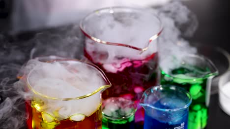 beakers with dry ice create colorful smoke