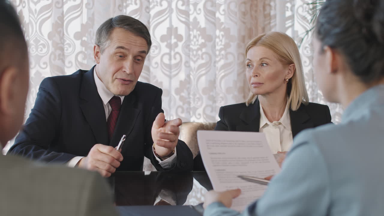 Business Partners Discussing Contract At Meeting Table