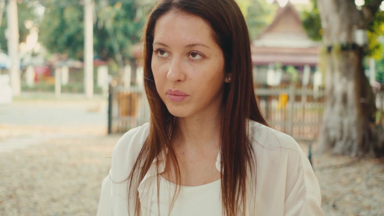 Young Woman Reading Tarot Cards at Outdoor Table
