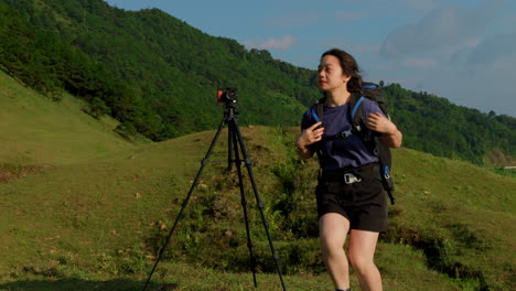 young-asiatic-influencer-posing-in-front-of-a-camera-on-a-tripod-for-a-photo-to-post-on-her-social-media