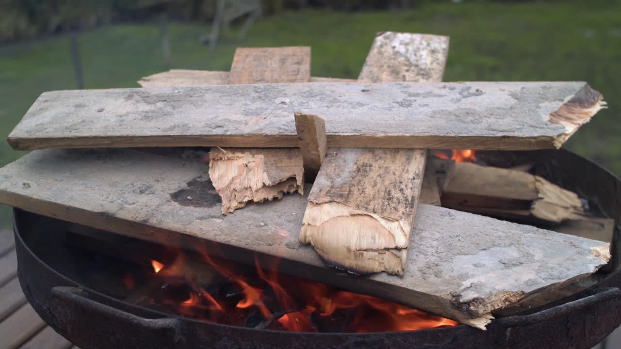 Wood Stacked on a Garden Fire Bowl - Close Up Flames, Static
