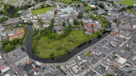 High-angle-footage-of-river-winding-through-town.-Aerial-panoramic-shot-of-city-from-height.-Ennis,-Ireland