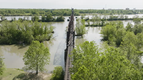 aerial pullback on railway bridge across arkansas river near lee creek park in arkansas