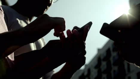 Bottom-view-of-young-people-using-smartphones.