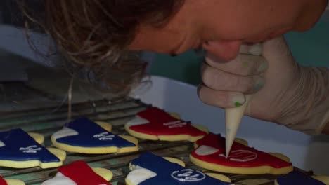 Woman-decorates-homemade-vehicle-shaped-cookies-with-sugar-icing