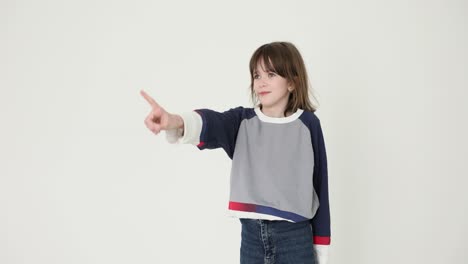 young girl making hand gestures in studio