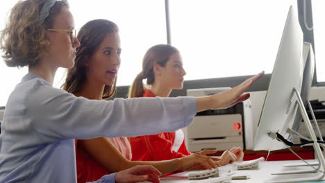 Business-executives-working-on-computer-at-desk