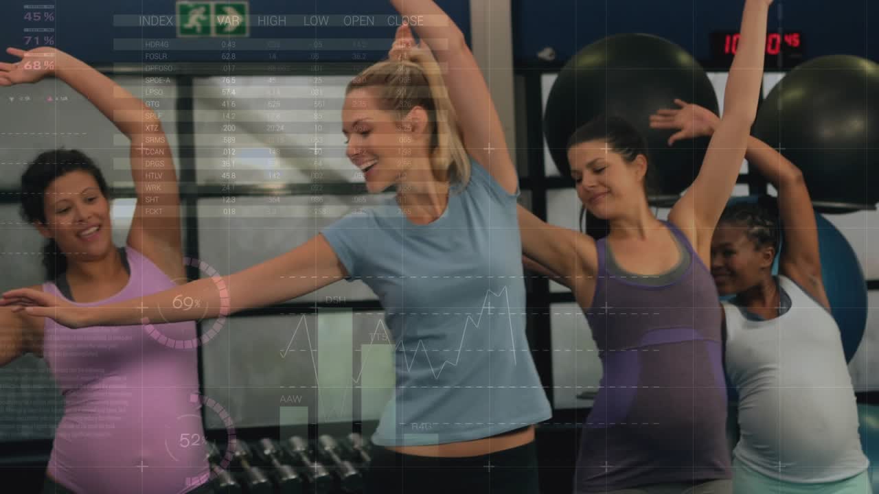 Trainer raising arm, leading pregnant group copying side stretch for prenatal class, HUD over frame