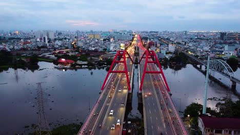 aerial view of highway and binh loi bridge in ho chi minh city, vietnam at dusk