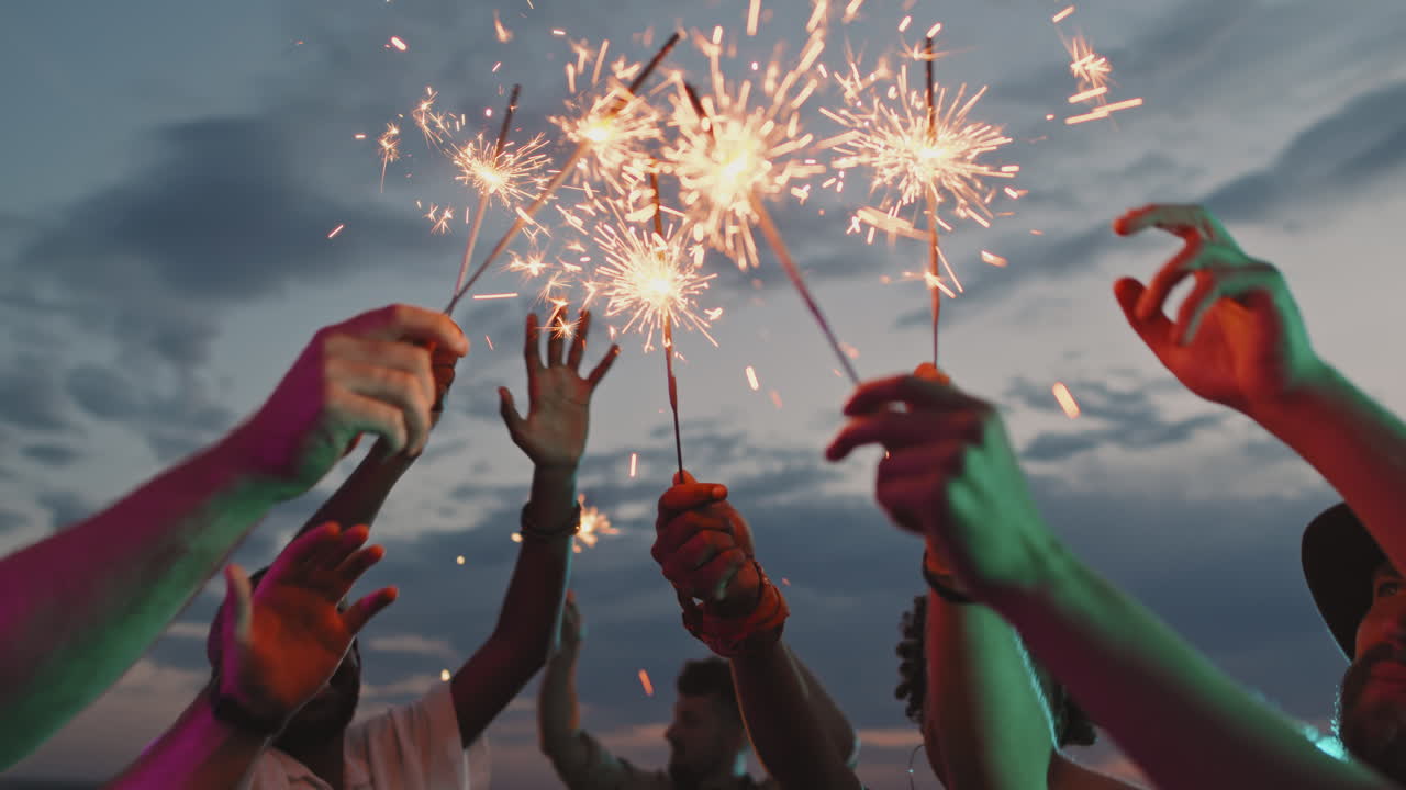 Group of People with Sparklers Partying on Rooftop