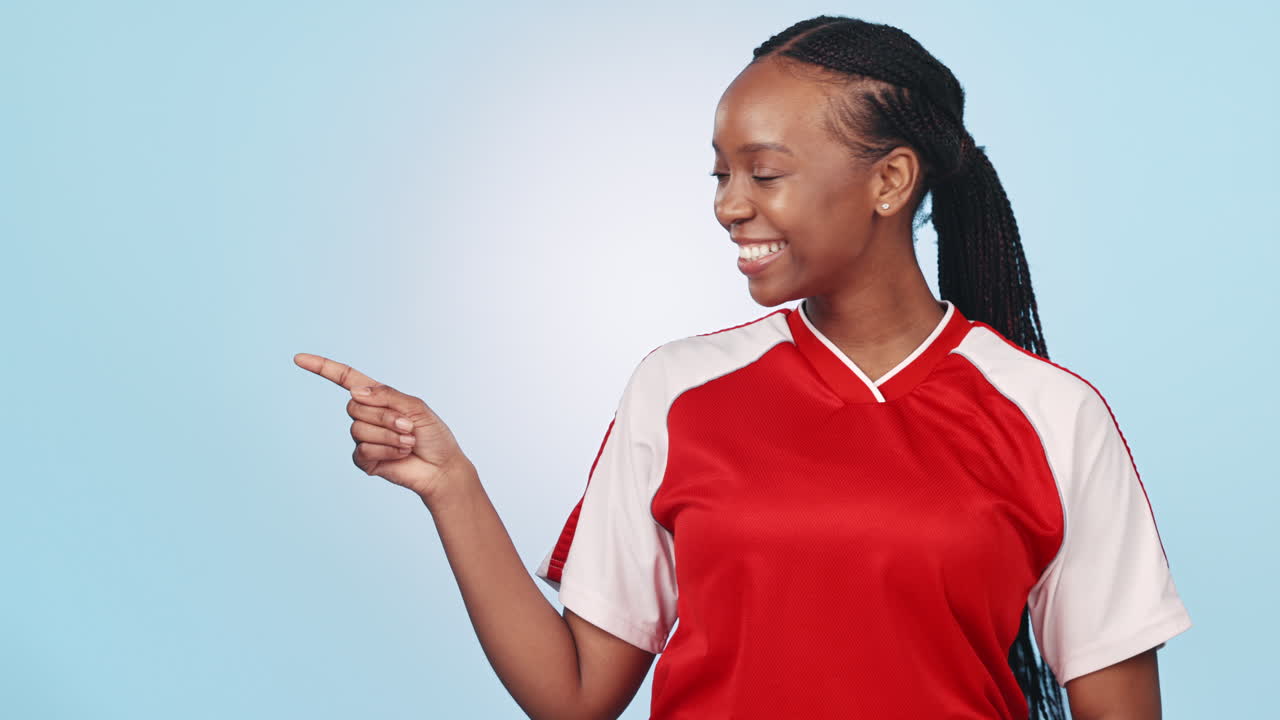 Sports woman, point and smile in studio