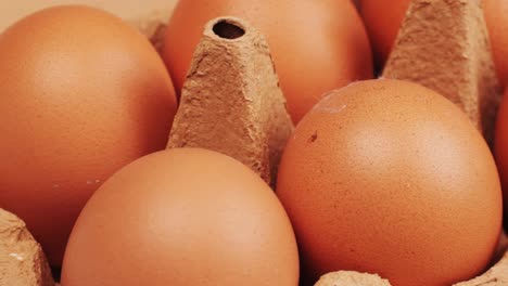fresh chicken eggs and dried straw on black wooden table, closeup. high quality 4k footage