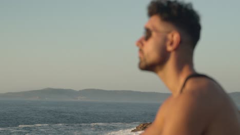 tranquil man enjoying seascape in summer at sunset