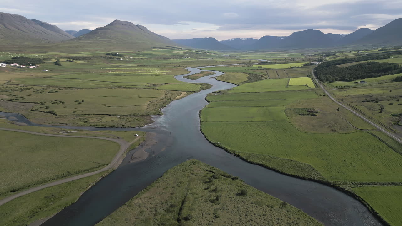 Aerial dolly upstream Akureyri Valley countryside, Iceland, natural backdrop