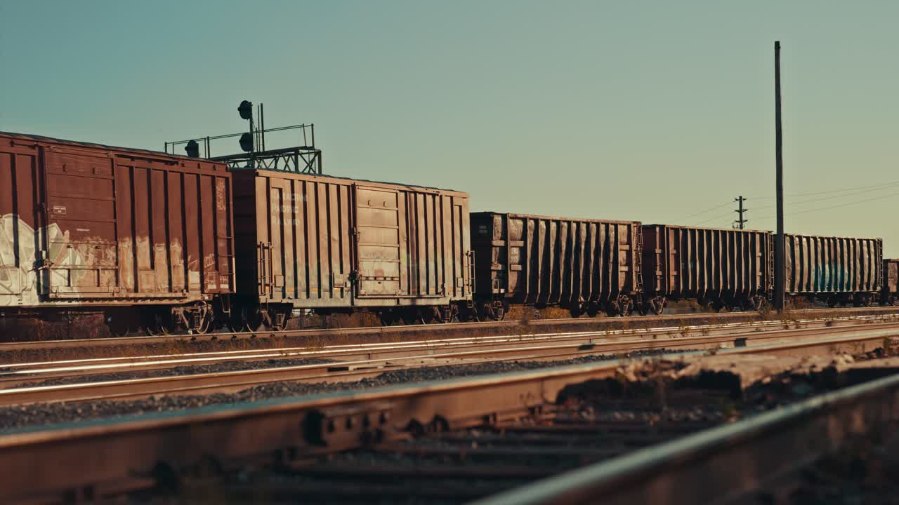 Freight Train Cargo Cars Coming to a Stop at Empty Industrial City Railway Yard