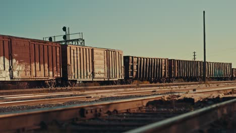 freight train cargo cars coming to a stop at empty industrial city railway yard