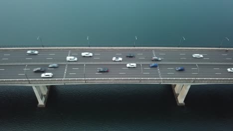 aerial: stationary drone shot of vehicles driving across captain cook bridge in sydney, nsw