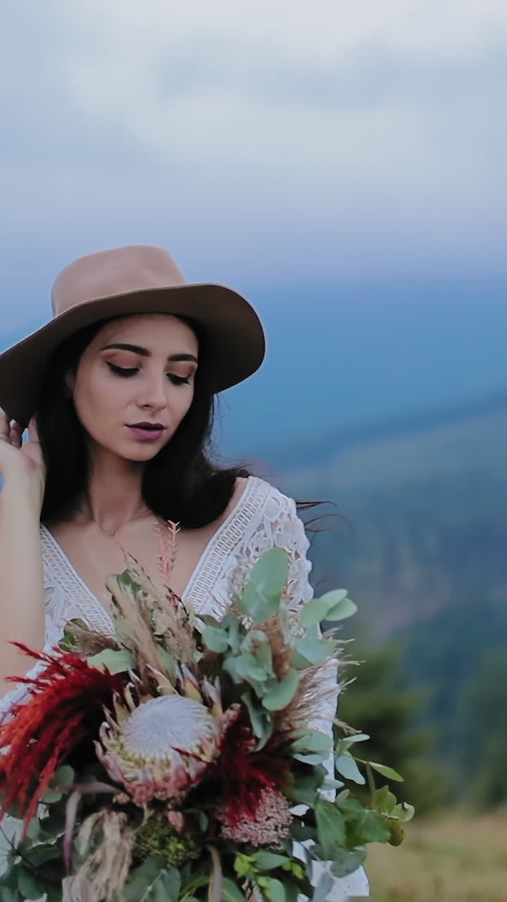 Bride posing near the mountains. Beautiful happy young bride posing on background of mountains
