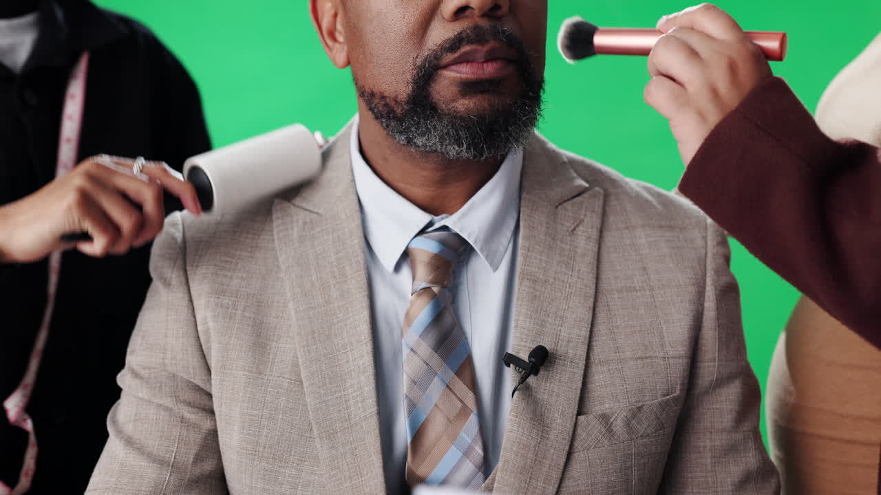 Man being groomed in front of green screen