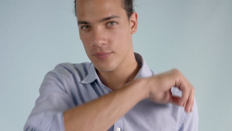 close up view of a young man sneezing and coughing to the elbow