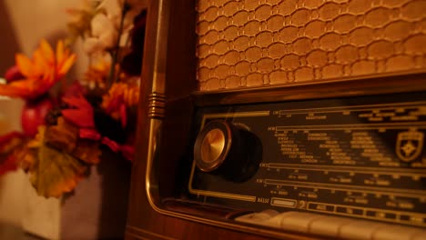 close-up of an antique radio with golden dials and mesh speaker, surrounded by autumn decor in warm, nostalgic lighting