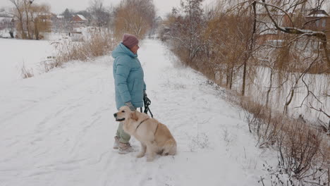 woman and dog enjoying a snowy day