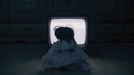 creepy doll watching tv