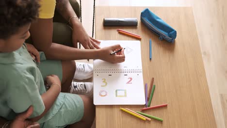 parent and child drawing numbers and shapes together