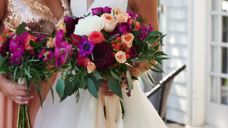 bride and bridesmaid holding bouquets