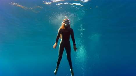 woman freediving underwater