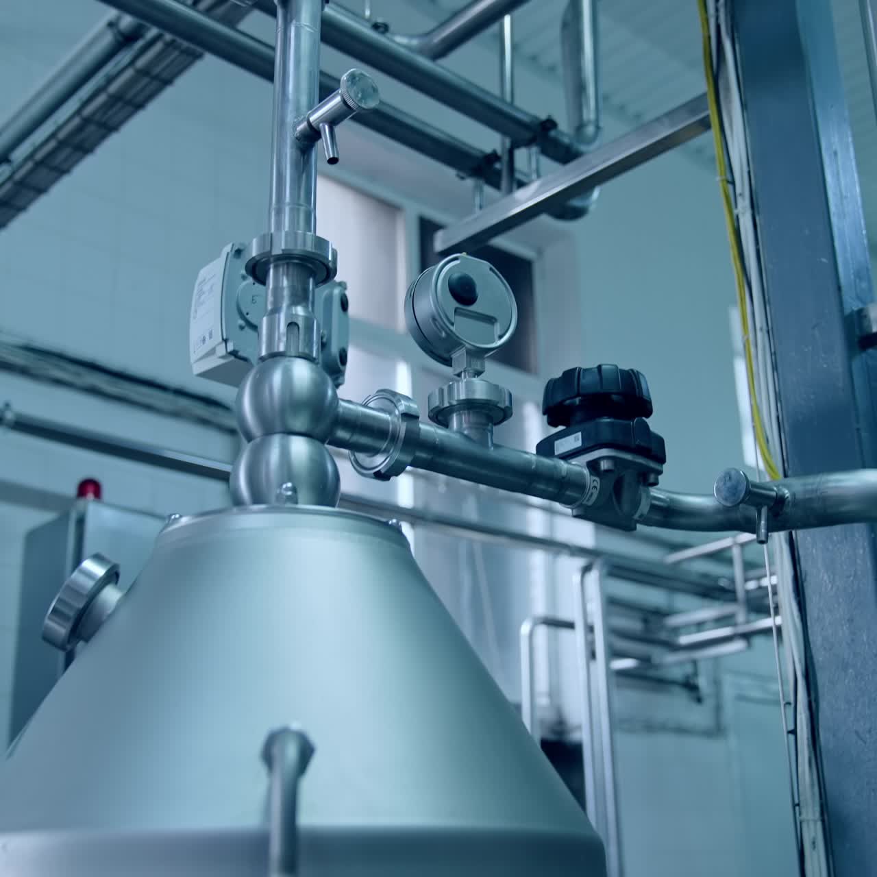 Complicated system of pipes interweaving with each other. Stainless steel tubes at the modern technological plant for producing dairy