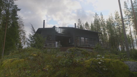 small countryside cabin on a hill in the forest in finland after heavy rain in autumn