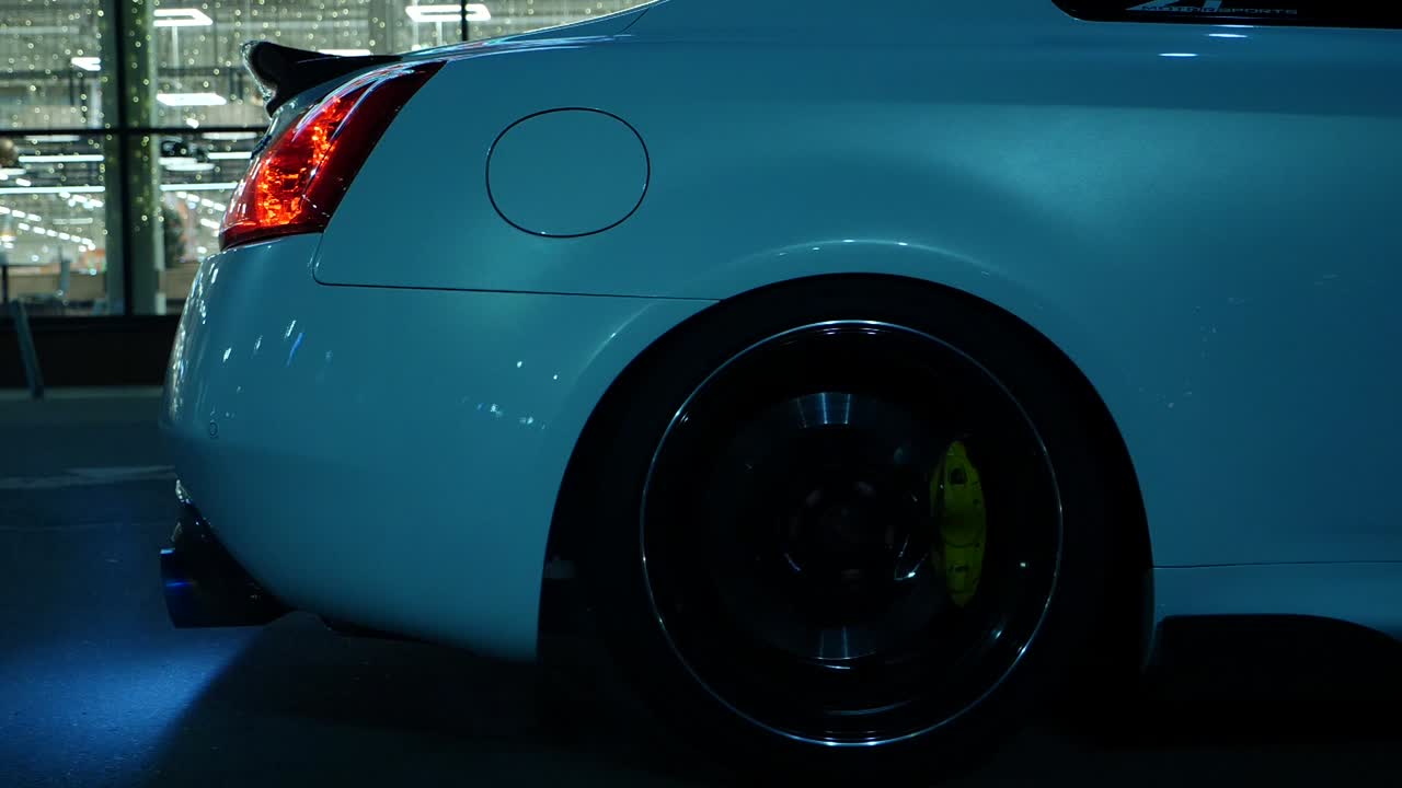 Close-up of a white sports car with custom wheels and brake