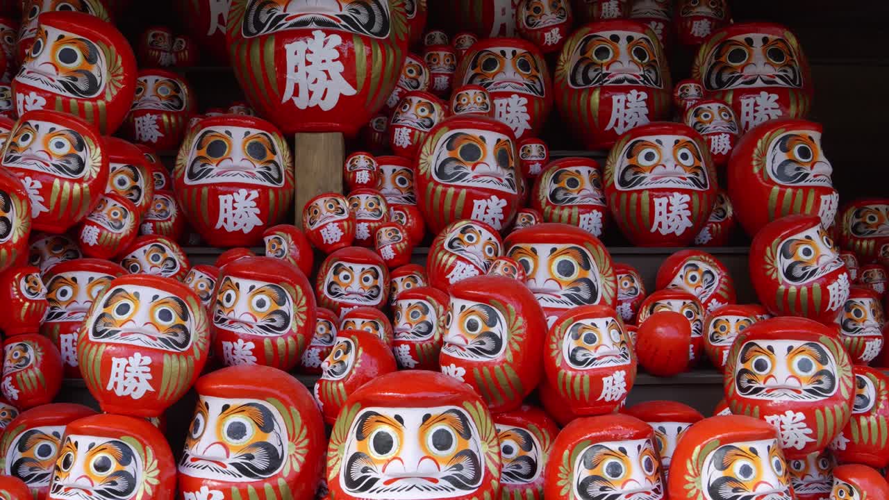 Slow cinematic dolly in toward Daruma dolls at Katsuoji shrine in Japan