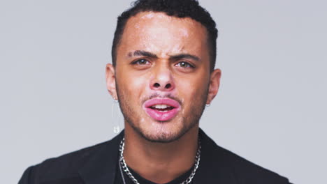 studio shot of angry man with skin pigmentation disorder shouting at camera in slow motion