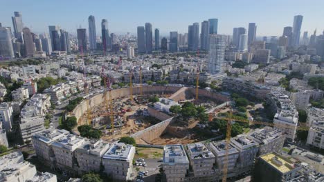 High-altitude-push-in-view-of-a-big-city-square-project-construction---skyscrapers-in-the-background