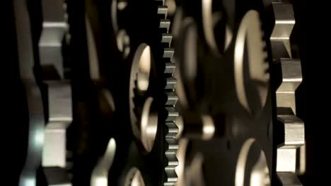 close up cogwheels of an industrial looking clock backlight