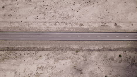 an empty stretch of desert highway in west texas, aerial view