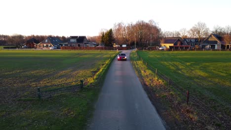 drone shot of alfa romeo car driving towards the camera