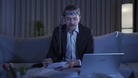 Cheerful-and-funny-businessman-working-at-night-at-home.