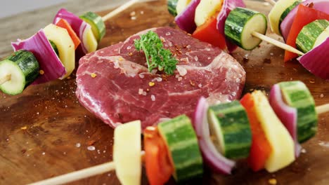 marinated steak and skewered vegetables on wooden board