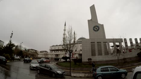 mosque and big watch passersby cars cloudy day after rain ankara