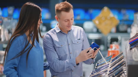 couple at tech store looking for a new mobile phone.