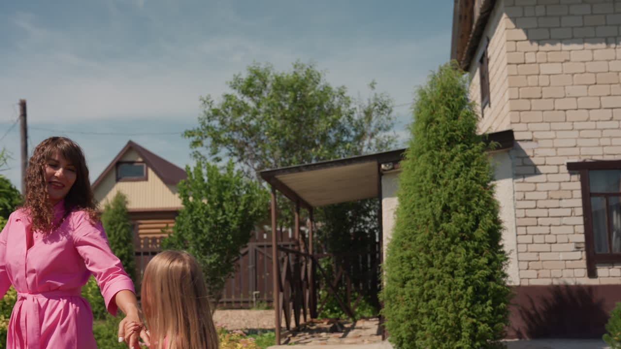 Mother And Child Enjoy Sunny Walk, Cheerful Walk With Parent And Kid Among Greenery And Sunlight, Parents And Children Wander Happily Through Flourishing Hedges Under Bright Shining Sun