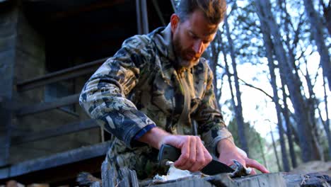 man shaping animal skin in the forest 4k