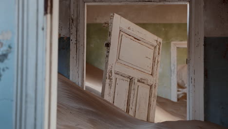 abandoned house buried in sand