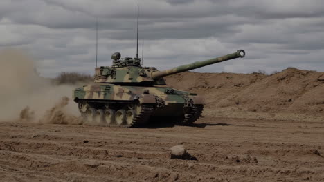 tank moving in desert terrain