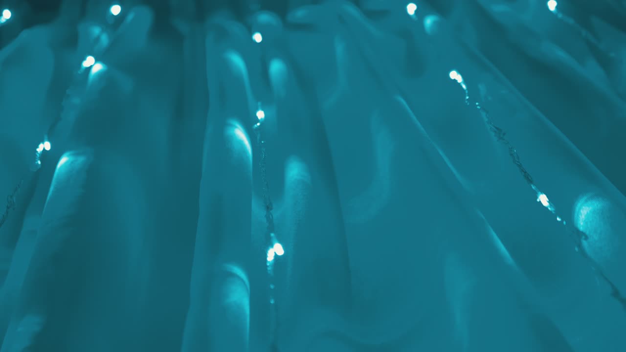 Christmas Garland of Many Blinking, Flickering Blue LED Lights on Curtain. 4K