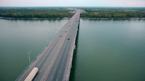 beautiful view of the bridge over the river passing cars through the bridge aerial