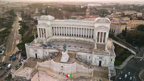 Beautiful-Orbiting-Drone-Shot-Above-Altare-della-Patria,-Altar-of-the-Fatherland-at-Sunrise-in-Rome,-Italy